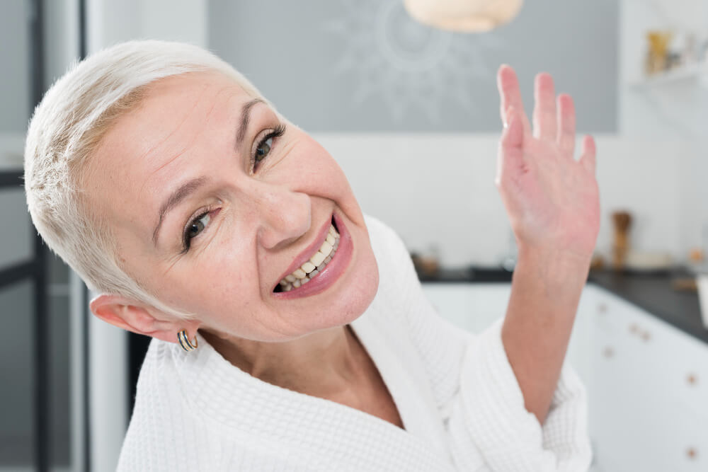 woman with white hair smiling widely