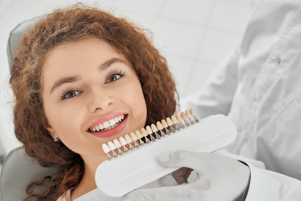 photo of a woman choosing the veneer shade to match her teeth