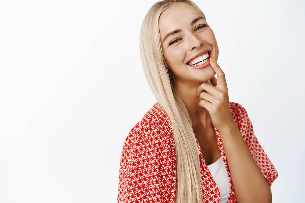 a woman showing off her perfect smile