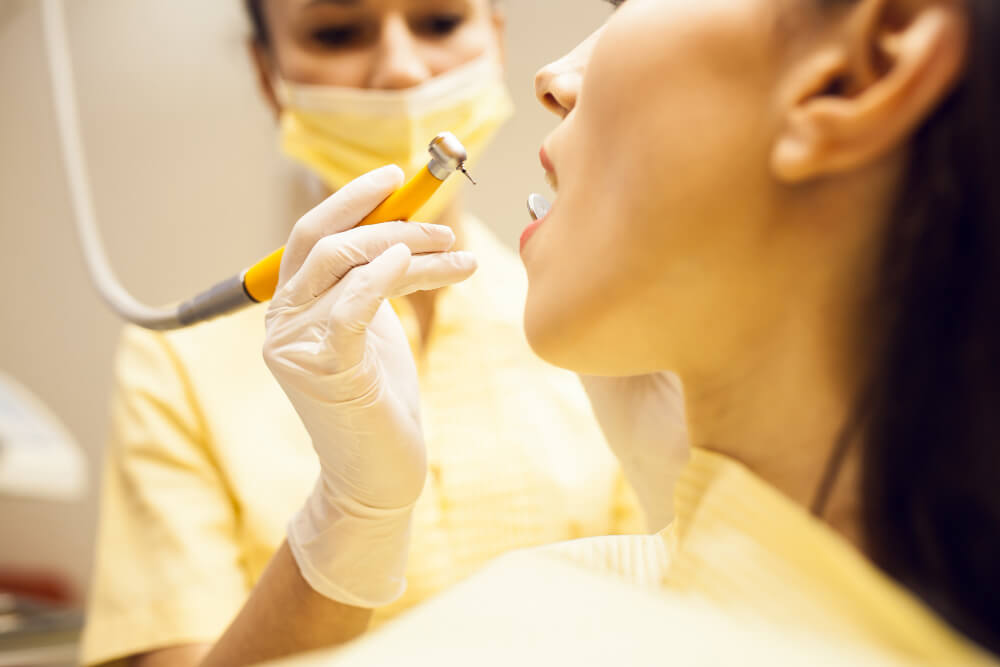 photo of a dentist and a patient during dental cleaning